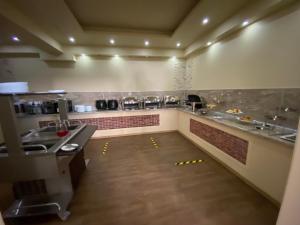 a large kitchen with a long counter in a restaurant at Lazur Beach by Stellar Hotels, Adler in Adler