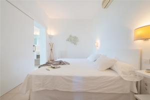 a white bedroom with a bed with white sheets at NEW! Villa ESPERANZA, Can Marilla, Front Sea View, Pool, AC, BBQ in Portocolom +46 photos