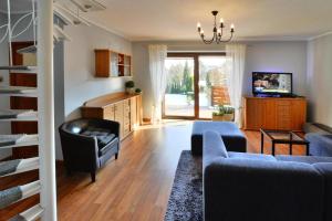 a living room with a couch and a table at holiday home, Kolobrzeg in Kołobrzeg