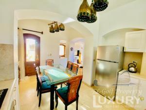 a kitchen with a table and a refrigerator at Private Villa Y51 - 3 BedRooms at El-Gouna in Hurghada