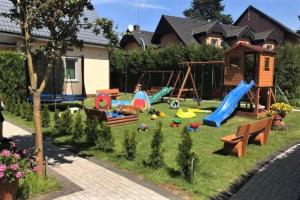 a backyard with a playground with a swing set at Holiday homes, Niechorze in Niechorze