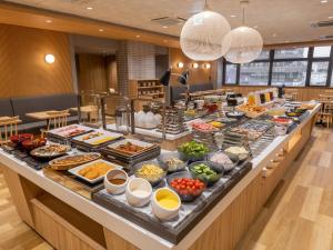 a buffet line with many different types of food at HOTEL MYSTAYS Soga in Chiba