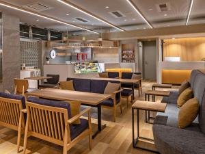 a restaurant with tables and chairs in a room at HOTEL MYSTAYS Soga in Chiba