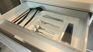 a white drawer with silver utensils in it at SYA Hotel-上呉服町 一軒家貸し切り in Fukuoka