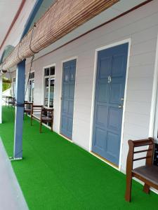 a house with green grass on the porch at Suhaila Palace in Perhentian Islands