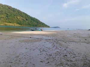 a boat on the shore of a beach at Suhaila Palace in Perhentian Islands