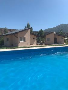 a view of a house from the water at Starry Lodge in Ciudad Lujan de Cuyo