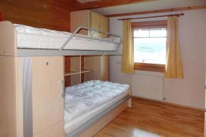 a bunk bed in a room with a window at Chalet Rabl, Westendorf in Westendorf