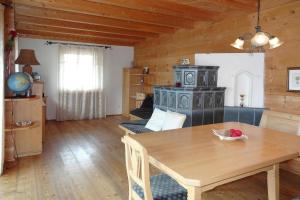 a living room with a table and a stove at Chalet Rabl, Westendorf in Westendorf