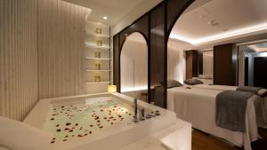 a bathroom with a tub filled with confetti at Jumeirah Beach Hotel Dubai in Dubai