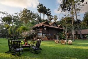 a group of chairs and tables in front of a house at Mane Family Vacation in Siem Reap