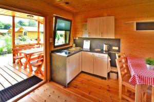 a kitchen in a cabin with a table and chairs at Holiday resort, Mielno in Mielno
