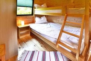 a bedroom with two bunk beds in a cabin at Holiday resort, Mielno in Mielno