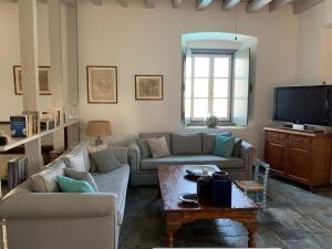 a living room with two couches and a tv at Villa 1853, Spetses Ground Floor in Spetses