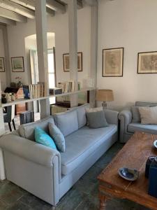 a living room with a couch and a table at Villa 1853, Spetses Ground Floor in Spetses