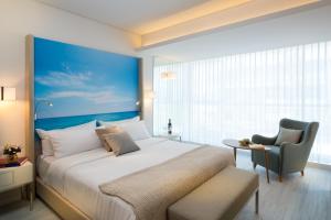 a hotel room with a large bed and a large window at Leonardo Plaza Netanya Hotel in Netanya