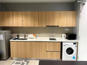 a kitchen with a sink and a washing machine at iCity 1Bedroom Apt Near Mall FREE PARKING & WIFI in Shah Alam