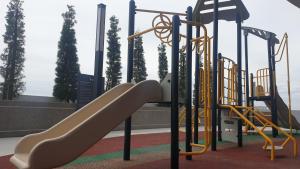 a playground with a slide in a park at Prestige Troika Luxury Stay in Kota Bharu