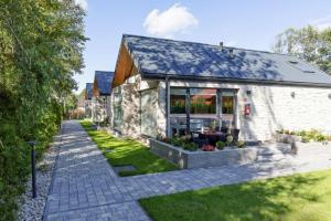 a stone house with a garden in front of it at Holiday Home in Ustronie Morskie near Beach in Ustronie Morskie