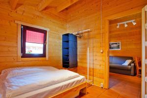 a bedroom with a bed in a wooden cabin at Row bungalows, Sianozety in Sianozety