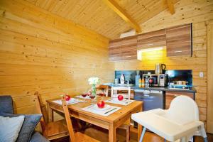 a wooden kitchen with a table and a kitchen at Row bungalows, Sianozety in Sianozety