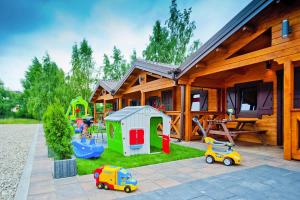 a house with a playground and toy cars in front of it at Row bungalows, Sianozety in Sianozety