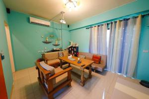 a living room with a table and a couch at 墾丁藍洞青旅 Blue Hole Backpacker Inn in Hengchun South Gate