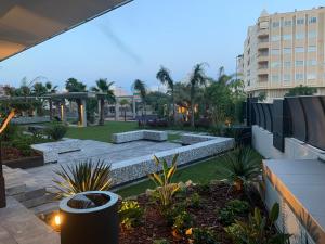 a view of a courtyard with benches and a park at Sol y Mar in El Campello