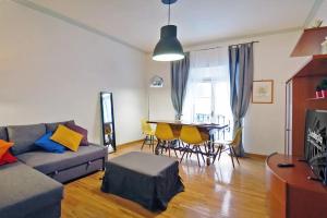 a living room with a couch and a table and chairs at Elegant Apartment Via Veneto by Varental in Rome