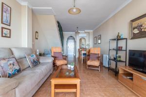 a living room with a couch and a table at Beautiful duplex in Salobreña in Salobreña