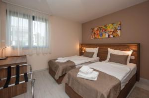 a bedroom with two beds and a window at Villa Marija in Sveti Filip i Jakov +104 photos