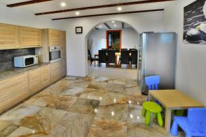 a kitchen with a table and a refrigerator at Villa in Swiecianowo near Baltic Sea in Paproty