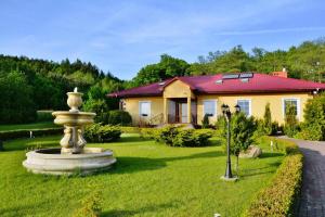 a house with a fountain in the yard at Villa in Swiecianowo near Baltic Sea in Paproty