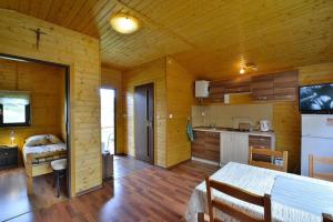 a kitchen and a dining room with a table in a room at holiday home, Rusinowo in Rusinowo