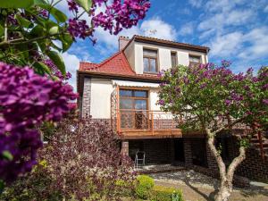 a house with a balcony and purple flowers at holiday home, Swinoujscie in Świnoujście