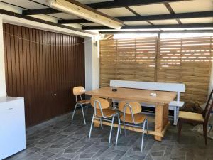 a table and chairs in a room with a wooden wall at JUNA in Karlsruhe