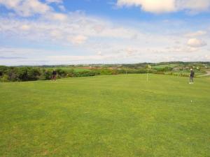 two people playing golf on a lush green field at Stone House in Plouarzel near Sandy Beaches in Plouarzel