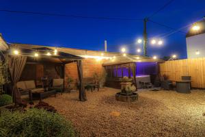 a patio at night with lights and a building at Little Lodge Walcote Lutterworth in Lutterworth