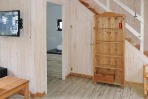 a room with a wooden staircase with a book shelf at holiday home, Nowe Warpno in Nowe Warpno