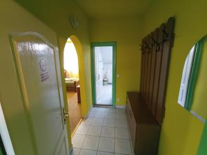 a small bathroom with a door open and a window at Pensiunea Cristina in Târgu-Mureş