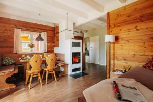 a living room with a dining table and a fireplace at Cottages, turf house in Torfhaus