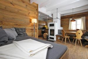 a bedroom with a bed and a dining room with a table at Cottages, turf house in Torfhaus