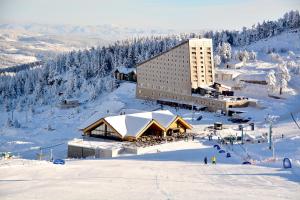 a building on top of a snow covered mountain at Dorukkaya Ski & Mountain Resort in Kartalkaya