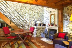 a living room with a table and a stone wall at holiday home, Grignan in Gourdon