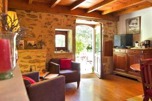 a living room with a couch and a tv at holiday home, Grignan in Gourdon