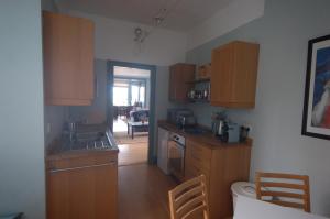 a kitchen with wooden cabinets and a sink at High St Flat in Edinburgh