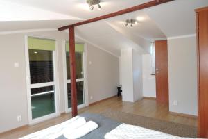 a bedroom with a bed and a large window at holiday home, Miedzyzdroje in Międzyzdroje