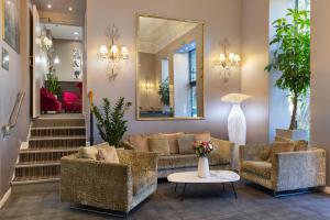 a lobby with a couch and chairs and a mirror at Best Western Hotel Lakmi Nice in Nice