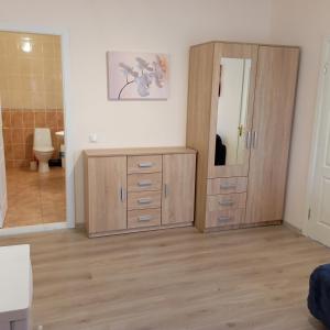 a room with a wooden cabinet and a mirror at У КоТа in Vinnytsya