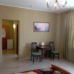 a dining room with a table and two chairs at У КоТа in Vinnytsya +77 photos